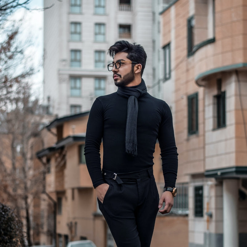 Stylish man wearing all black turtleneck outfit on city street